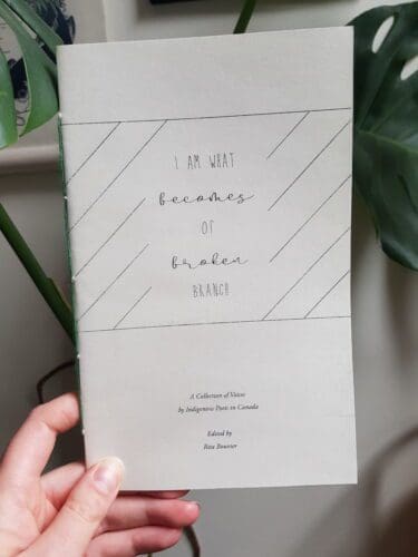 A hand holding a copy of I am what becomes of broken branch