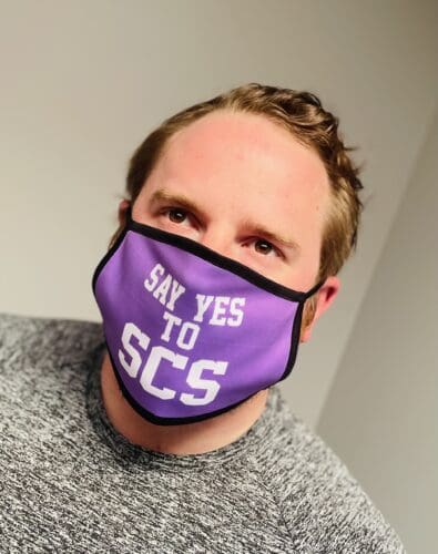 Corey Ranger headshot; wearing a mask that says "Say Yes to SCS"