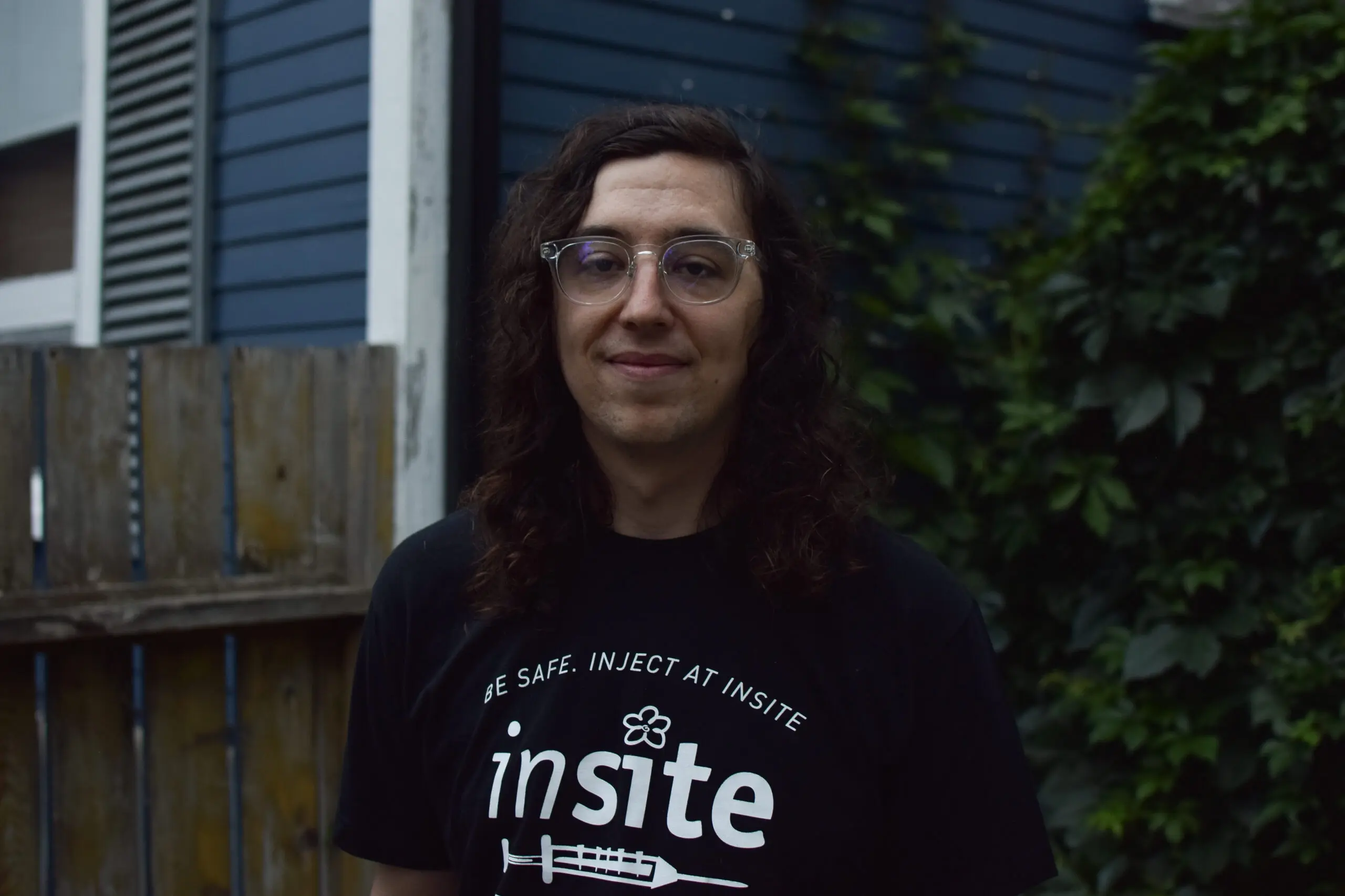 Spenser Smith headshot; wearing a shirt that says "Be Safe. Inject at Insite"